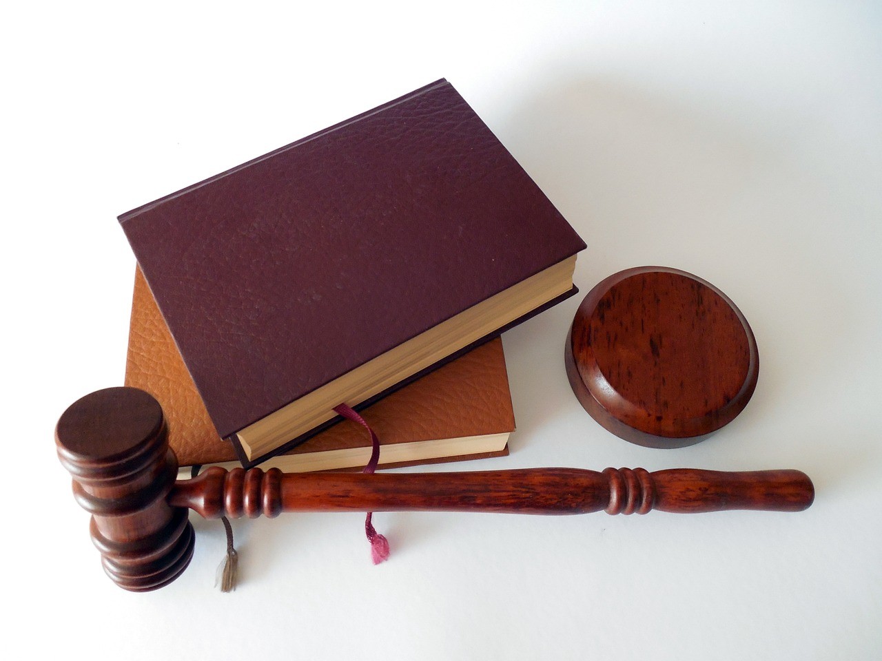 Law books and a judges gavel sit on a table